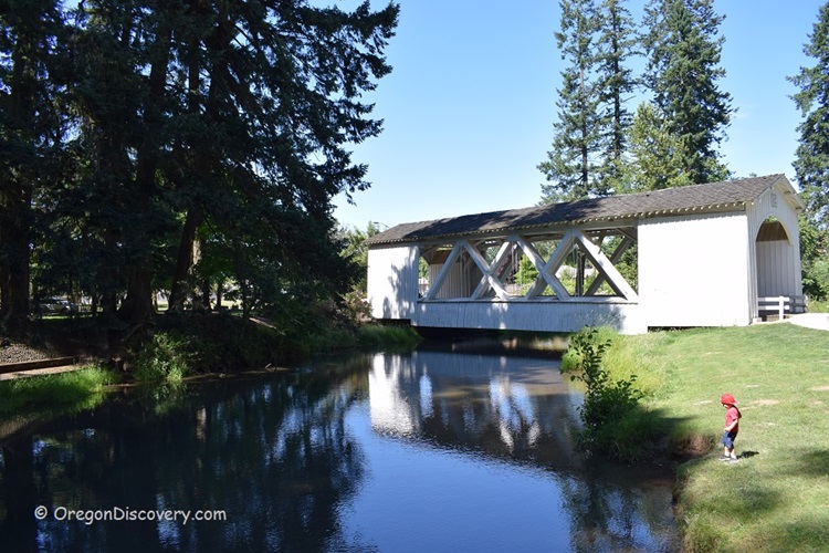 The Stayton-Jordan Covered Bridge spanning a river in a forested setting